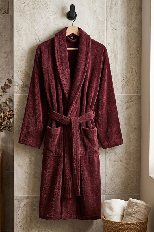 White cotton Turkish towel from TORK with intricate traditional patterns, displayed folded on a wooden surface.