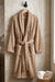 White cotton Turkish bath towel by TORK, showing soft texture and traditional design, perfect for comfortable, luxurious use.
