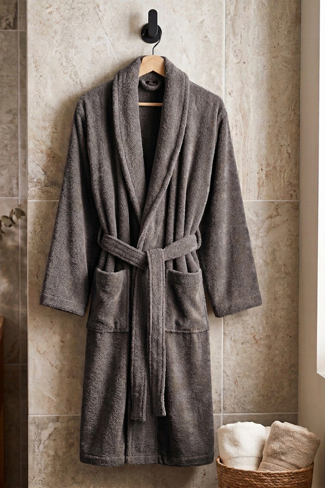 Soft white cotton Turkish bathrobe from TORK, shown hanging with a plush texture and cozy design.