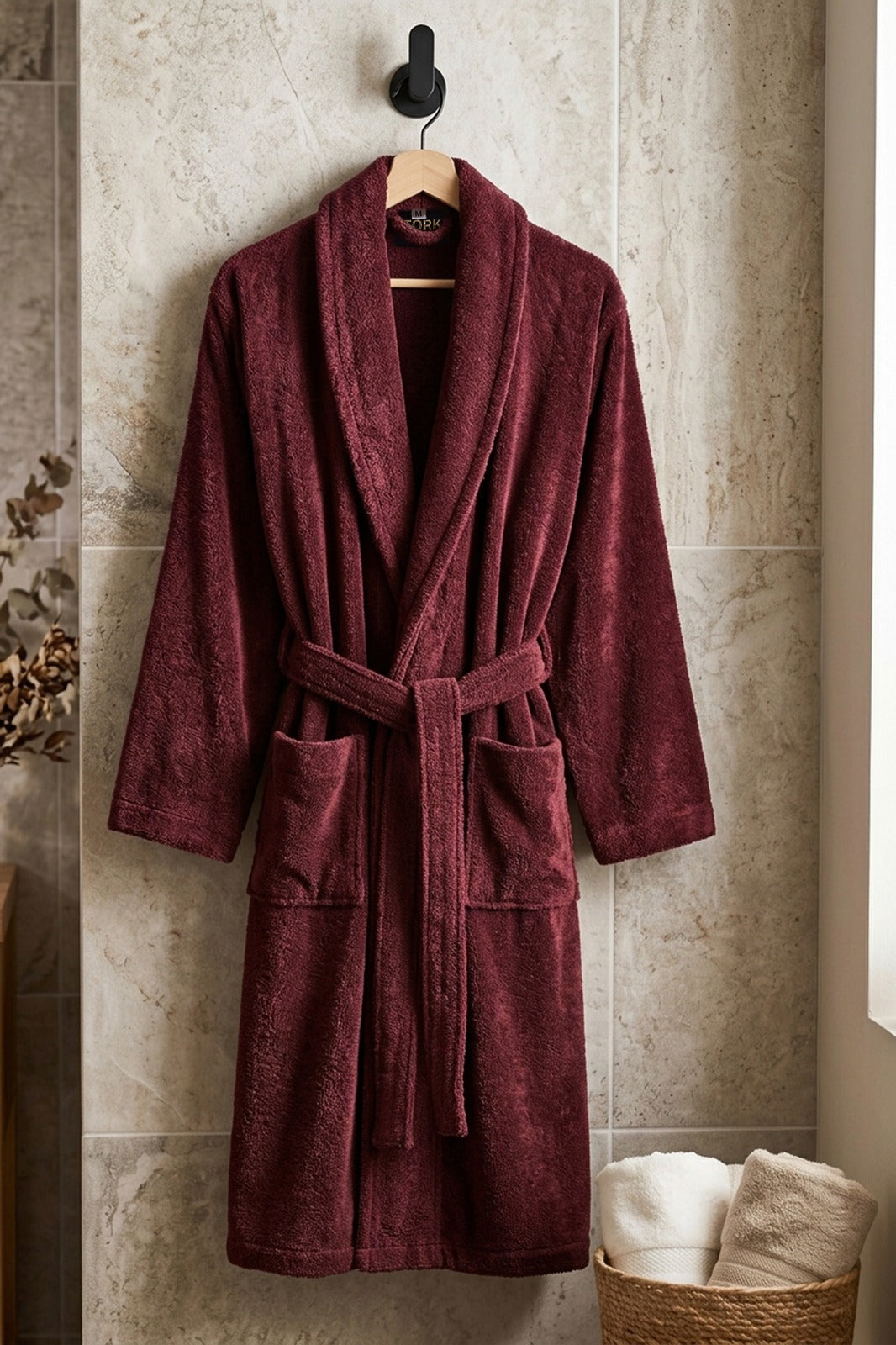 White cotton Turkish towel from TORK with intricate traditional patterns, displayed folded on a wooden surface.