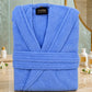 Soft white cotton Turkish bath towel by TORK, shown folded with textured fabric and fringed edges.